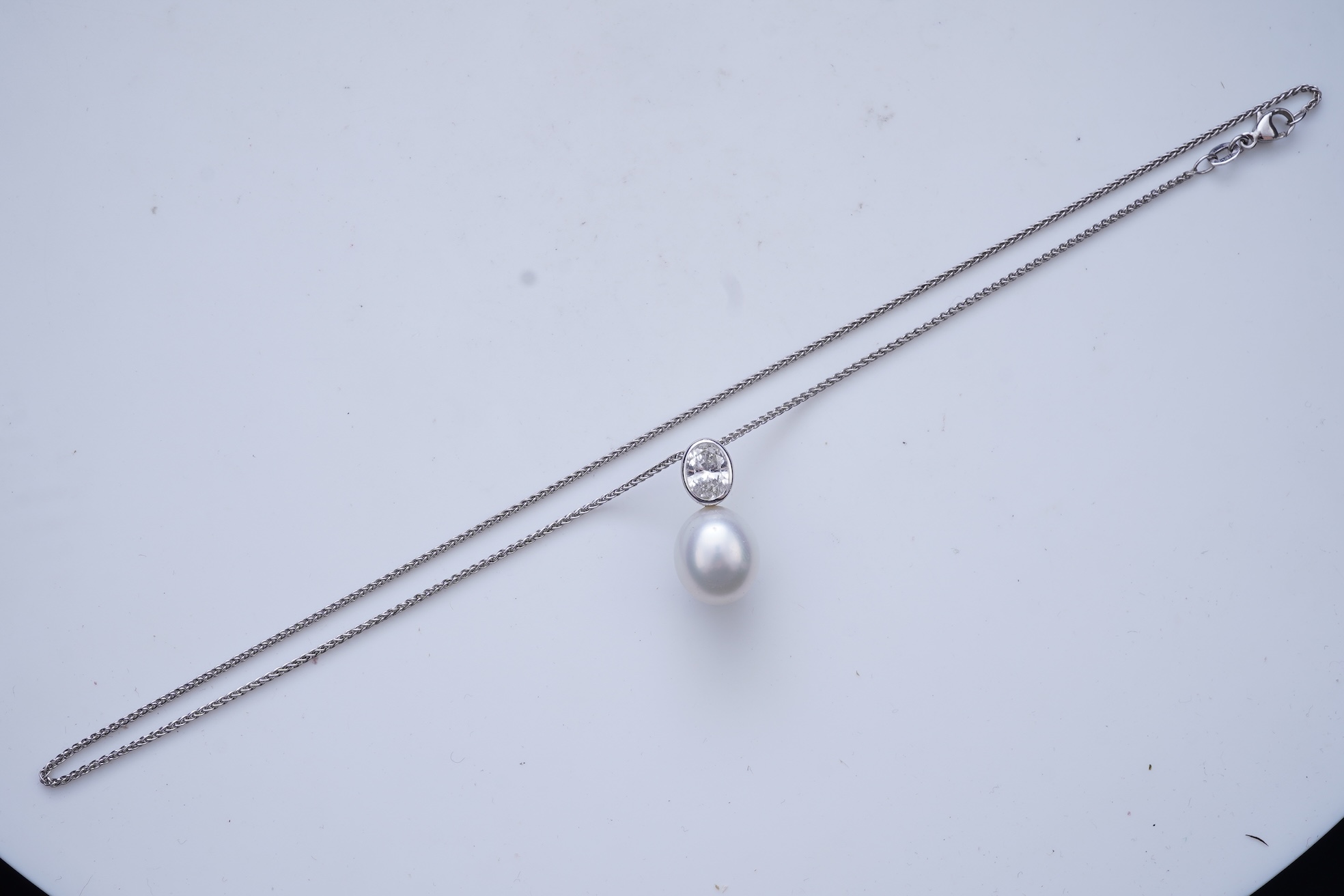 A cultured pearl and diamond pendant